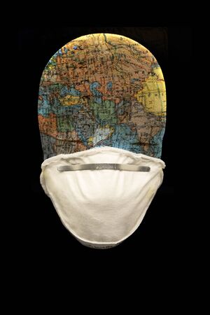 N95 mask with manakin head depicting the globe in black backgroundの写真素材