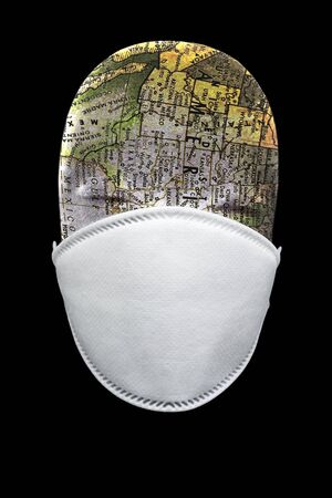 N95 mask with manakin head depicting the globe in black backgroundの写真素材