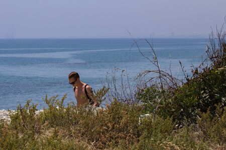 boy walking on the beach, Cyprusの写真素材