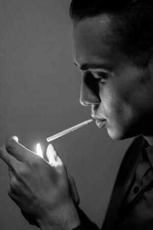 cute smoking boy in the roomの写真素材