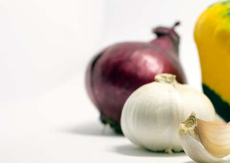 spotted squash on a white background, onion and garlicの写真素材