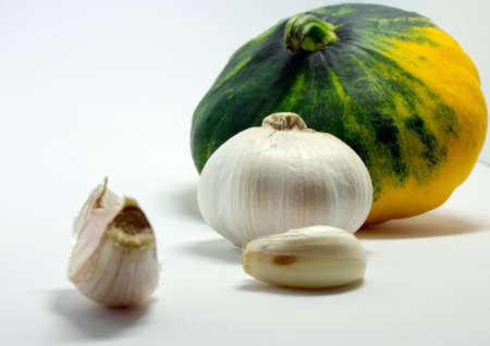 spotted squash on a white background and garlicの写真素材