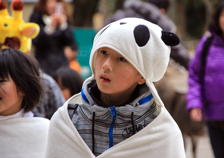 little boy in a panda costume walking in the park. Nara, Japanのeditorial素材