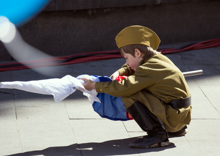 2018.09.05, Moscow, Russia. Victory Day in Moscow. A boy wearing a military uniform with a Russian flag on a parade of Victory Day.のeditorial素材