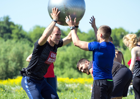 2018.05.26, Moscow, Russia. Moscow fitness festival in the historical park. Team playing with a big ball on the field.のeditorial素材
