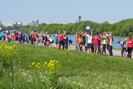 2018.05.26, Moscow, Russia. Moscow fitness festival in the historical park. Team playing with a big ball on the field.のeditorial素材