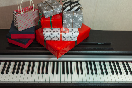 Colorful present boxes on the piano. Christmas decoration of Interior.の写真素材