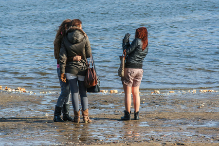 2010.03.27, Moscow, Russia. Group of young girls on background of river. People walking in the park.のeditorial素材
