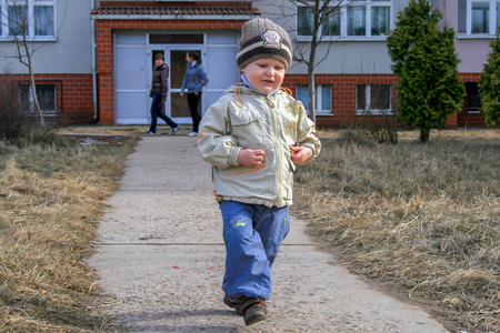 2010.04.02, Maloyaroslavets, Russia. Little boy playing in the yard. emotions of a little funny kid.のeditorial素材