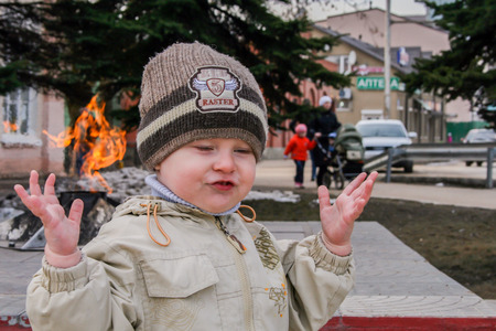 2010.04.02, Maloyaroslavets, Russia. Little boy playing in the yard. emotions of a little funny kid.のeditorial素材