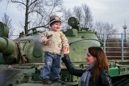 2010.04.02, Maloyaroslavets, Russia. little boy climbing by the tank. mother and sonのeditorial素材