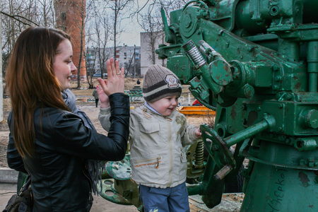 2010.04.02, Maloyaroslavets, Russia. little boy climbing by the tank. mother and sonのeditorial素材