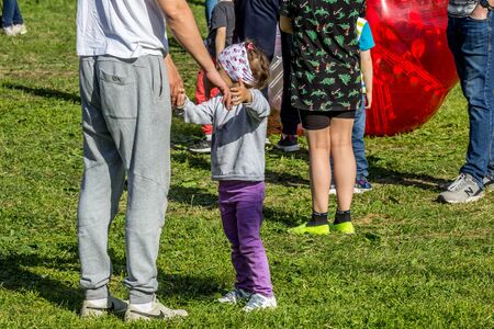 2019.06.01, Moscow, Russia. Dad whirling daughter around him. Father playing his daughter on the field.のeditorial素材