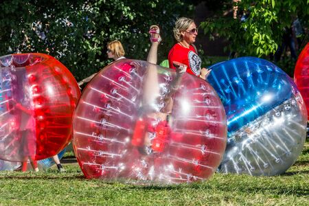 2019.06.01, Moscow, Russia. Entertainment of zorbing in the park. Children rolling downhill inside an orb (sphere). Enjoy of childhood.のeditorial素材