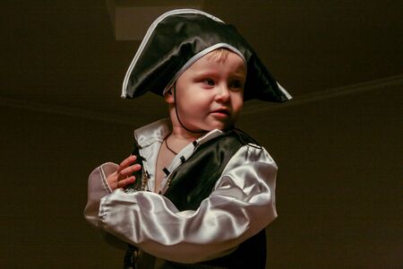 2010.11.28, Maloyaroslavets, Russia. A little boy wearing a pirate costume holds a spyglass....