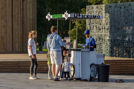 08.08.12, Moscow, Russia. Mom and dad buy ice cream for their children in the park. Happy family walking in sunny day.のeditorial素材