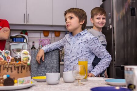 2019.02.09, Maloyaroslavets, Russia. Happy birthday party at home. A little kid (birthday boy) going to blow out the candle on the cake.のeditorial素材