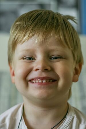 Portrait of a little blonde hair kid looking at camera.