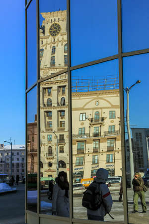 01/28/2012, Minsk, Belarus. Multi-storey pseudo-stalinist empire building with the clock on top and...