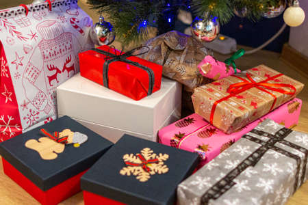 12/29/2018, Moscow, Russia. gifts wrapped in colorful bright paper lie under the Christmas tree. A...