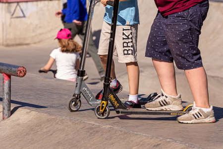 05/26/2018, Moscow, Russia. Group of different age boys riding a scooter at a skatepark. Active lifestyle of modern russian children.のeditorial素材