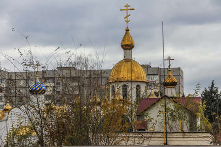 2012.12.02, Krasnodar, Russia. Cityscape with an old curch in the city on background of gray sky.