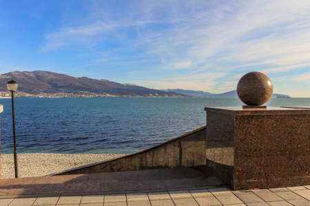 12/09/2012, Novorossiysk, Russia. Seascape by the shore against the background of the cruiser and mountains.のeditorial素材