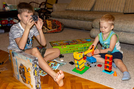 31.12.2018, Maloyaroslavets, Russia. two boys unfold their gifts in the early morning. festive mood concept.のeditorial素材