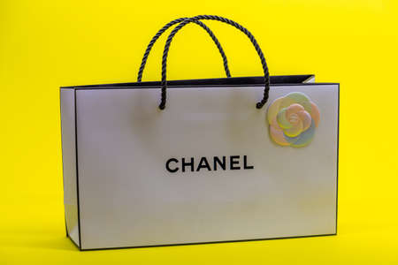 08.10.2020, Moscow, Russia. White Chanel bag on yellow background.