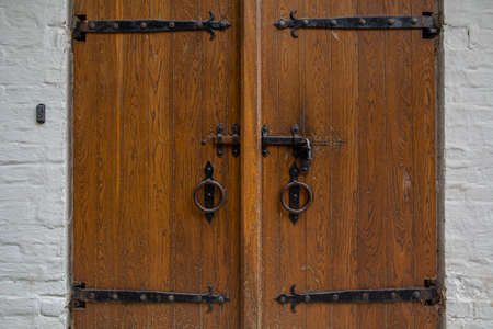 padlock on ancient wooden gate. Elements of an old historical building.