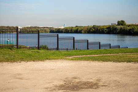 metal fence near the river in the park. Moscow cityscape in Kolomenskoye park.の写真素材