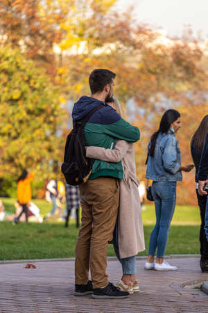 09/27/2020, Moscow, Russia. A young loving couple hugging while standing in the park.