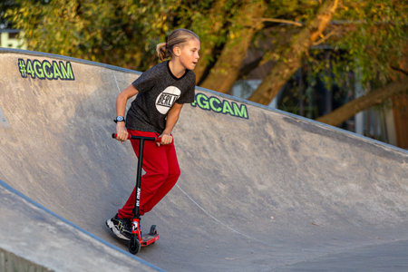 09/27/2020, Moscow, Russia. Af teenager boy scooter riding in the park. Study of extreme sports on the open air.のeditorial素材
