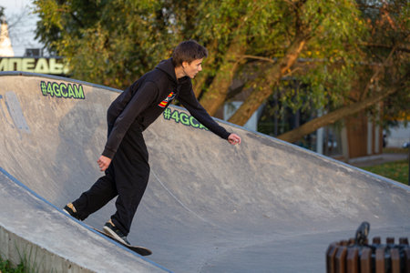 09/27/2020, Moscow, Russia. A teenager boy skateboarding in the park. Study of skateboarding of...