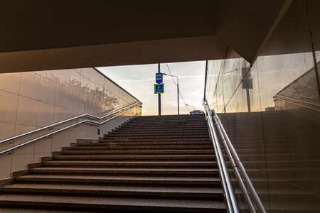 underpass staircase and road sign on background of sky, bottom viewの写真素材