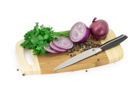 greens, parsley, peppers, onions on a kitchen boardの写真素材