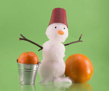 Snowman isolated on green backgroundの写真素材