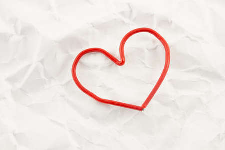 red heart on a background white crumpled office paper