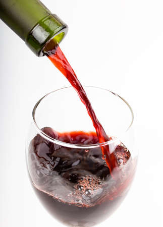 pour a glass of wine isolated on white backgroundの写真素材