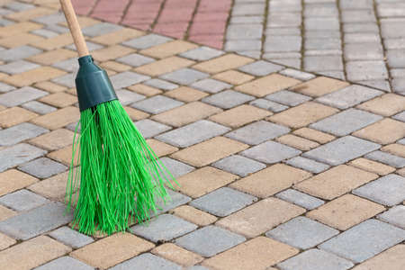 a broom to clean the sidewalk tilesの写真素材