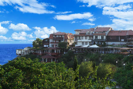 houses on a hill by the sea sky の写真素材