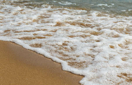 sandy beach, sea shore with wavesの写真素材