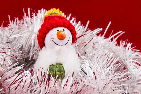 christmas ball snowman tinsel on a red backgroundの写真素材