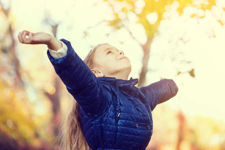 young girl freedom autumn parkの写真素材