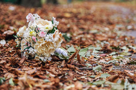 bouquet of roses on yellow autumn leavesの写真素材