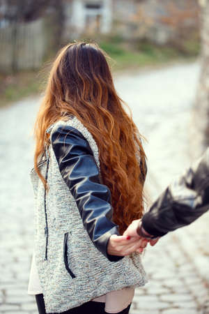 couple follow me holding hands