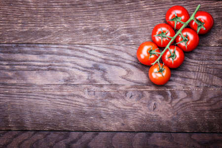 tomato on a wooden table backgroundの写真素材