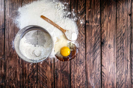 flour, egg, sieve board on a wooden board