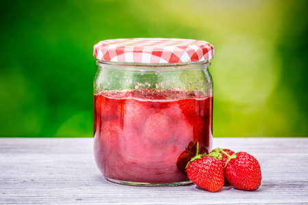 jar strawberry jam blur nature wooden tableの写真素材