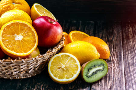 orange, lemon, fruit, kiwi, apple on a wooden board
